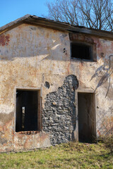 Fototapeta premium Ruins of an Abandoned Historic Brick Mansion Under Blue Sky