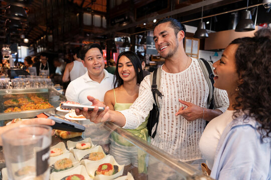 Friends purchasing food enjoying contactless payment lifestyle