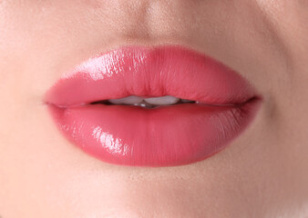 Obraz premium Woman with beautiful pink lipstick on her lips, macro view