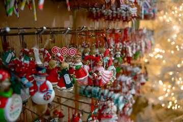 Colorful Christmas ornaments hanging on display with twinkling lights creating a festive holiday atmosphere