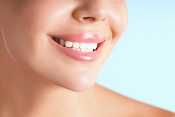 Obraz premium Woman with beautiful lips on light blue background, macro view