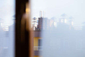 Blurry image of a city skyline with a building in the foreground