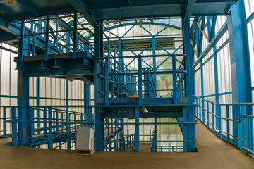 Large empty building made of glass and metal. The building is empty, there is no one inside