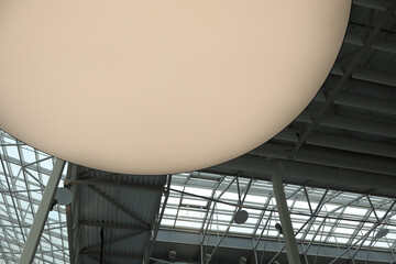 A large lamp on the ceiling of an industrial or commercial space.