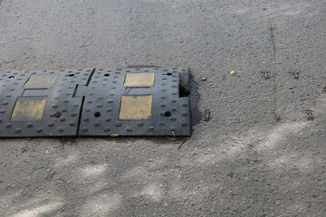 Broken speed bump on the road