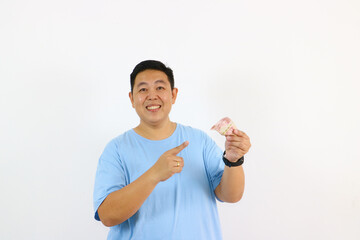 Happy young asian man showing money
