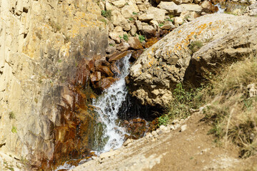 Continuation of the Abai-Su waterfall flows over rugged rocks, nestled within  rocky landscape, showcasing nature's raw and serene beauty. Kabardino-Balkaria, Chegemsky district