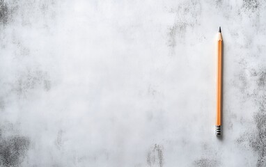 A single orange pencil placed on a textured light gray background, offering ample copy space for design or text