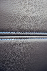 The leather is a deep brown color with blue stitching