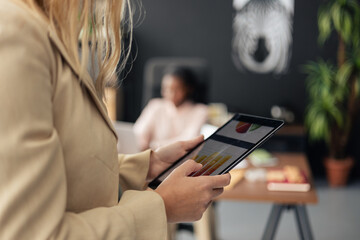 Businesswoman analyzing data on digital tablet in meeting