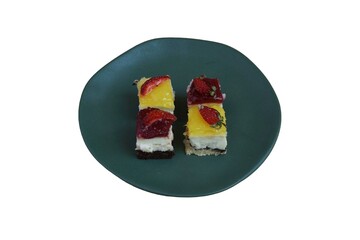 Four small fruit cakes on a plate isolated on white background