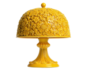 A vibrant yellow dome-shaped lamp, adorned with intricate floral carvings, placed on a detailed pedestal