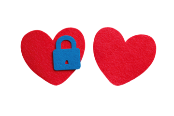 Two red heart shapes, one with a blue lock on, isolated against a black background