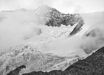 Monte Rosa (Italy) - A mountains view in Valsesia with Monte Rosa mount peak of Alps, alpinistic paths to Rifugio Modena and Capanna Margherita refuge, with snow glacier and alpinists.