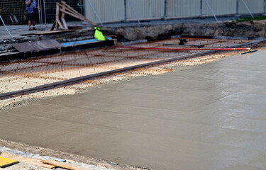 rebar meshes made of steel grids are poured with concrete from the mix. Theodolite measures the...