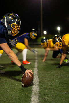 American football players lining up night game