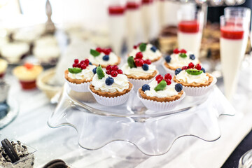 Dessert buffet or candy bar during catering event, fruits and whipped cream