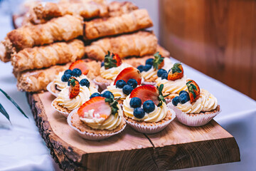 Dessert buffet or candy bar during catering event, fruits and whipped cream
