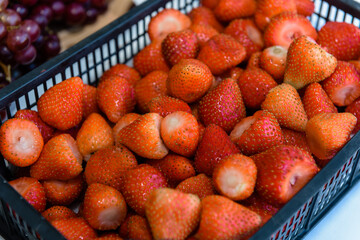 There are a lot of strawberries in the drawer. Sweet delicious berry, natural vitamins.