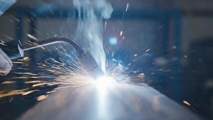 Close up of a welder working with sparks flying.