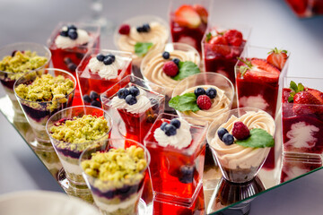 Dessert buffet or candy bar during catering event, fruits and whipped cream