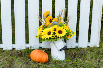Still life with sunflowers and pumpkin. Autumn gifts of nature.