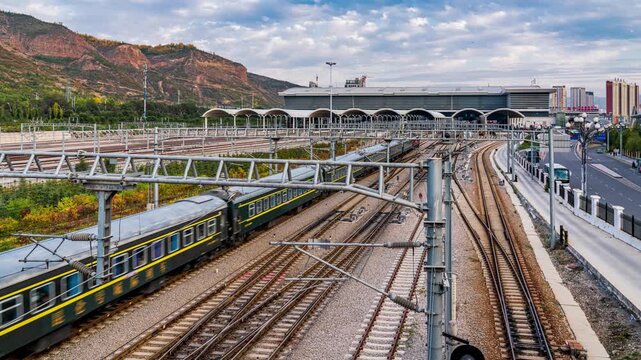 Xining Railway Station with Multiple Train Tracks and Mountain Landscape in China