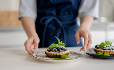 Girl Holding Blueberry Dessert