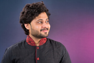Obraz premium Portrait of a happy young Indian traditional man posing