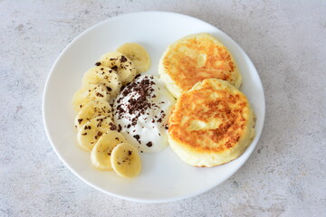 Breakfast Plate with Pancakes, Banana Slices and Cream flat lay