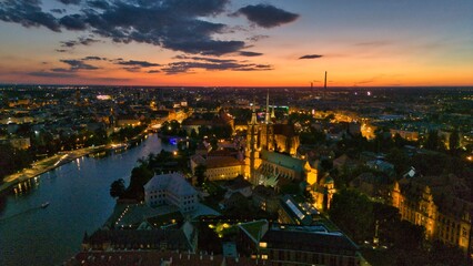 Evening Panorama of Wrocław – Aerial View of Ostrów Tumski with Illuminated Street Lamps