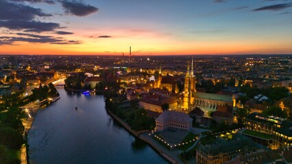 Evening Panorama of Wrocław – Aerial View of Ostrów Tumski with Illuminated Street Lamps