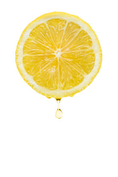 Lemon slice with drops of juice, isolated on white background.