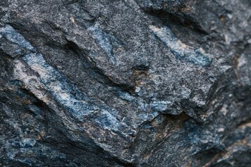 Close-up shot revealing texture and color of rough-hewn, layered rock formation with blue streaks