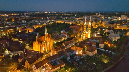 Evening Panorama of Wrocław – Aerial View of Ostrów Tumski with Illuminated Street Lamps
