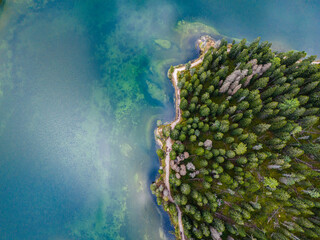 Aerial view of breathtaking landscape of Lake Misurina and hotel. Dolomites mountain in background, IAlpine lake in the Italian Alps. Drone view of Lago di Misurina. Mountain forest lake with a view.