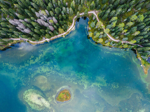 Aerial view of breathtaking landscape of Lake Misurina and hotel. Dolomites mountain in background, IAlpine lake in the Italian Alps. Drone view of Lago di Misurina. Mountain forest lake with a view.