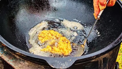 Golden fried food in a pan, crispy and delicious cooking experience