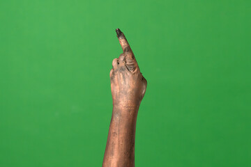 A creepy zombie hand points upward