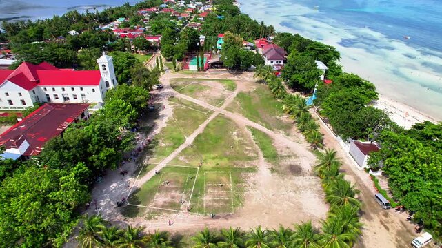 4k Drone Footage of Anda Church, Bohol, Philippines. Hoovering forward, showcasing the church and town. 