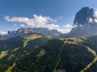 Aerial view of Monte Pana from Val Gardena, Dolomites, Italy. Ski slopes in summer. Langkofel mountain peak. Dolomite Mountain Ranges In South Tyrol. Beautiful Dolomites Panorama. Big mountain ridge. 