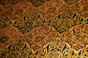 Luxurious ornate panel with gold, red, and blue motifs and intricate embroidery