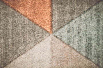The backdrop is adorned with intricate, abstract patterns in a variety of hues.