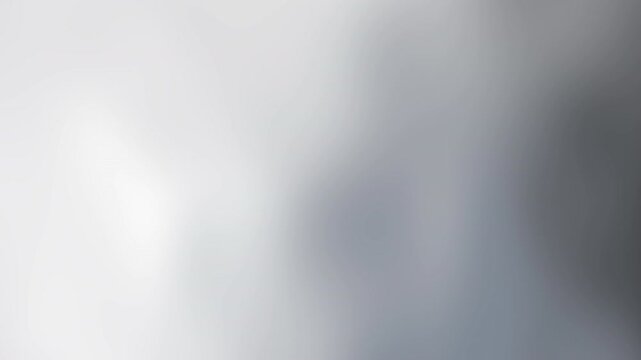 Soft, hazy gradient scene with pale whites and cool blues blending into softened grayish atmosphere