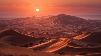 Naklejka premium Golden sunrise over vast rolling sand dunes in the sahara desert, morocco with warm glowing sky and natural desert landscape