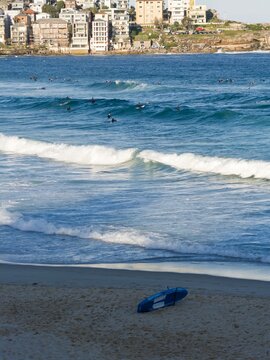 Ocean waves rolling with street light pole in view