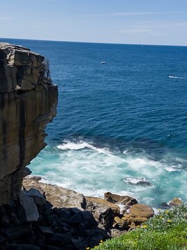 Powerful ocean waves crashing against coastal rocks