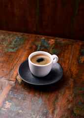 Cup of coffee on rustic wooden background. Soft focus. Copy space	