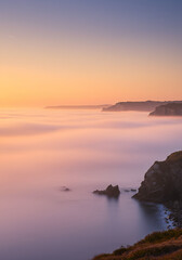Soft Light on Rocky Coastline and Low-Lying Marine Layer
