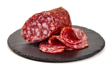 Salami Napoli with slices, cured meat on slate plate, isolated on white background